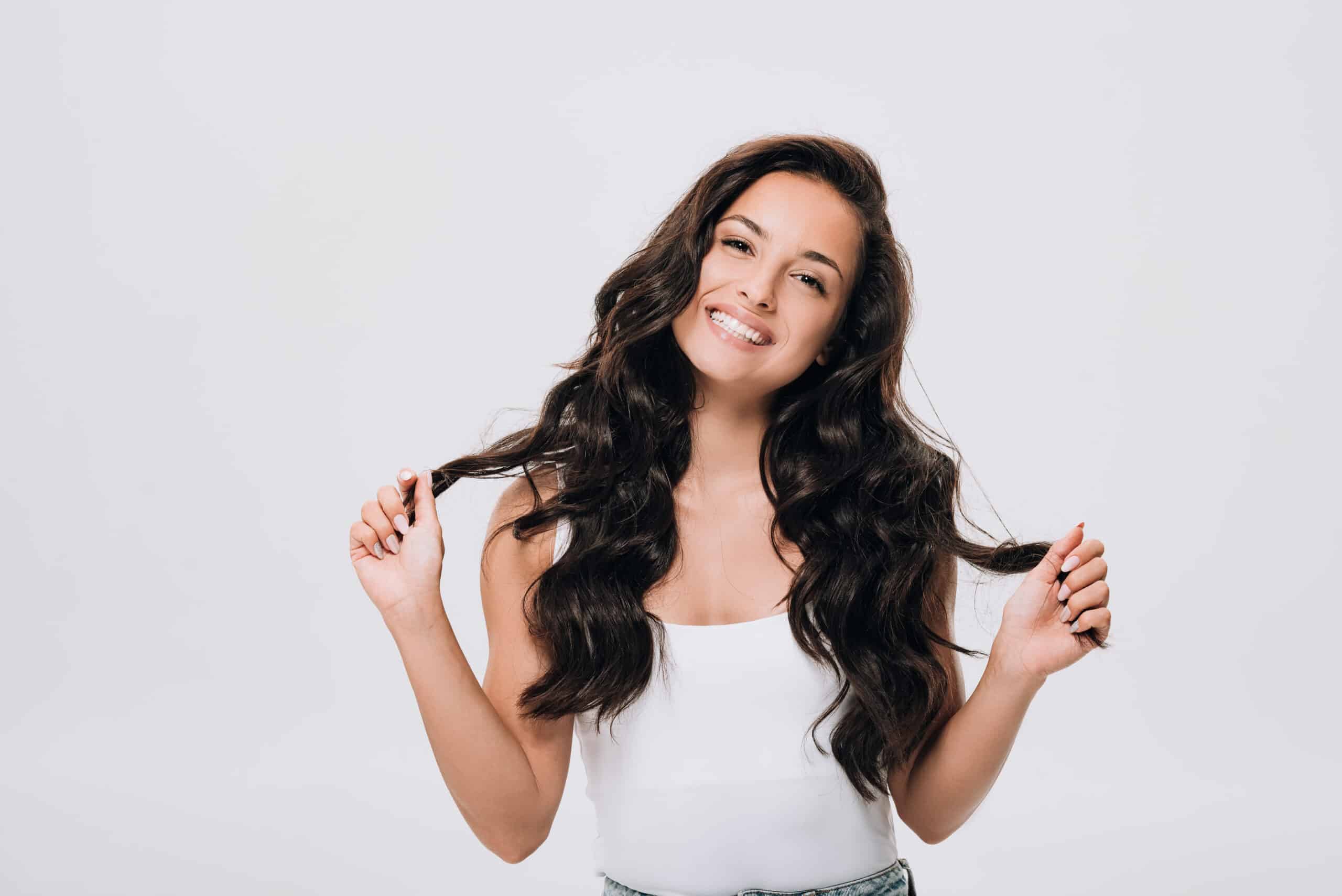 happy brunette beautiful woman with long curly healthy hair isol