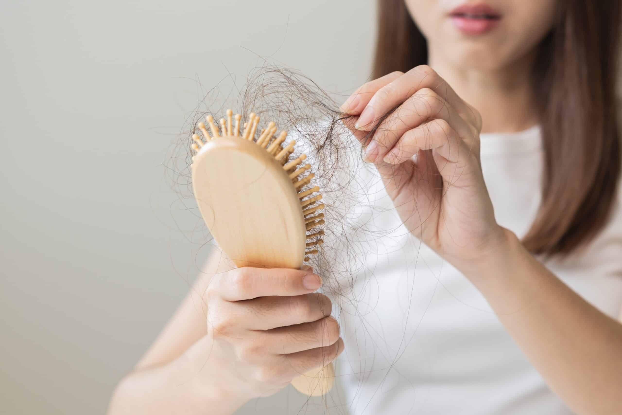 hairbrush with fall black hair from scalp after brushing hairbrush with fall black hair from scalp after brushing