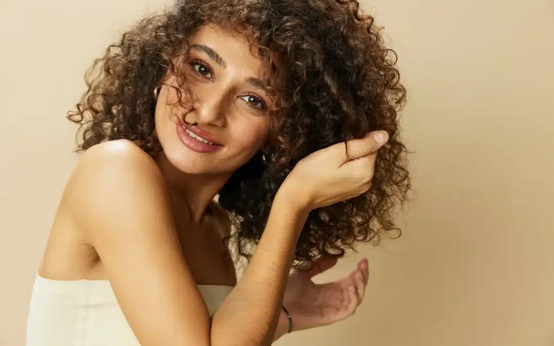 Beautiful Woman touching her curly hair