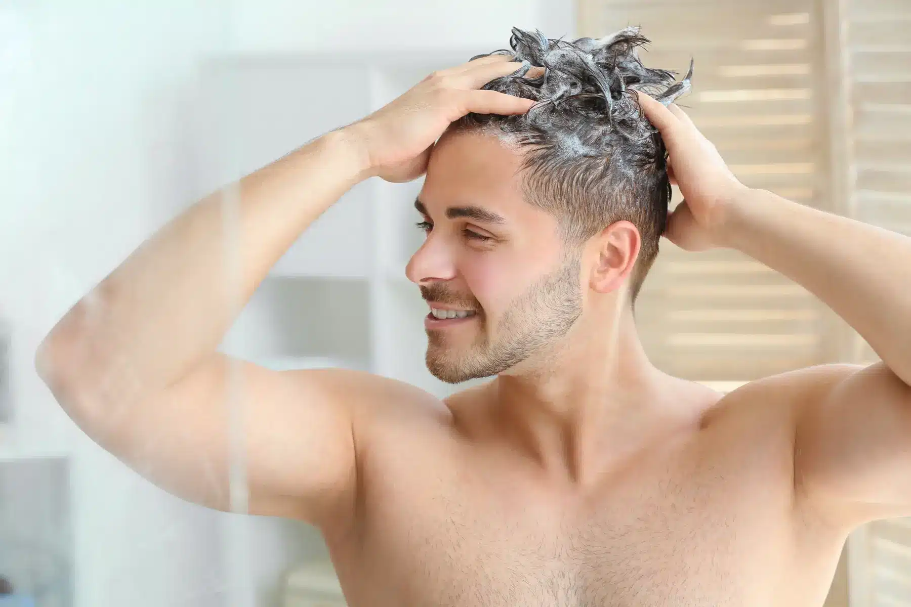 Man washing his hair after a hair restoration treatment in Tampa, FL